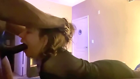 Busty brunette with a sexy pair of black stockings sucking on a cock